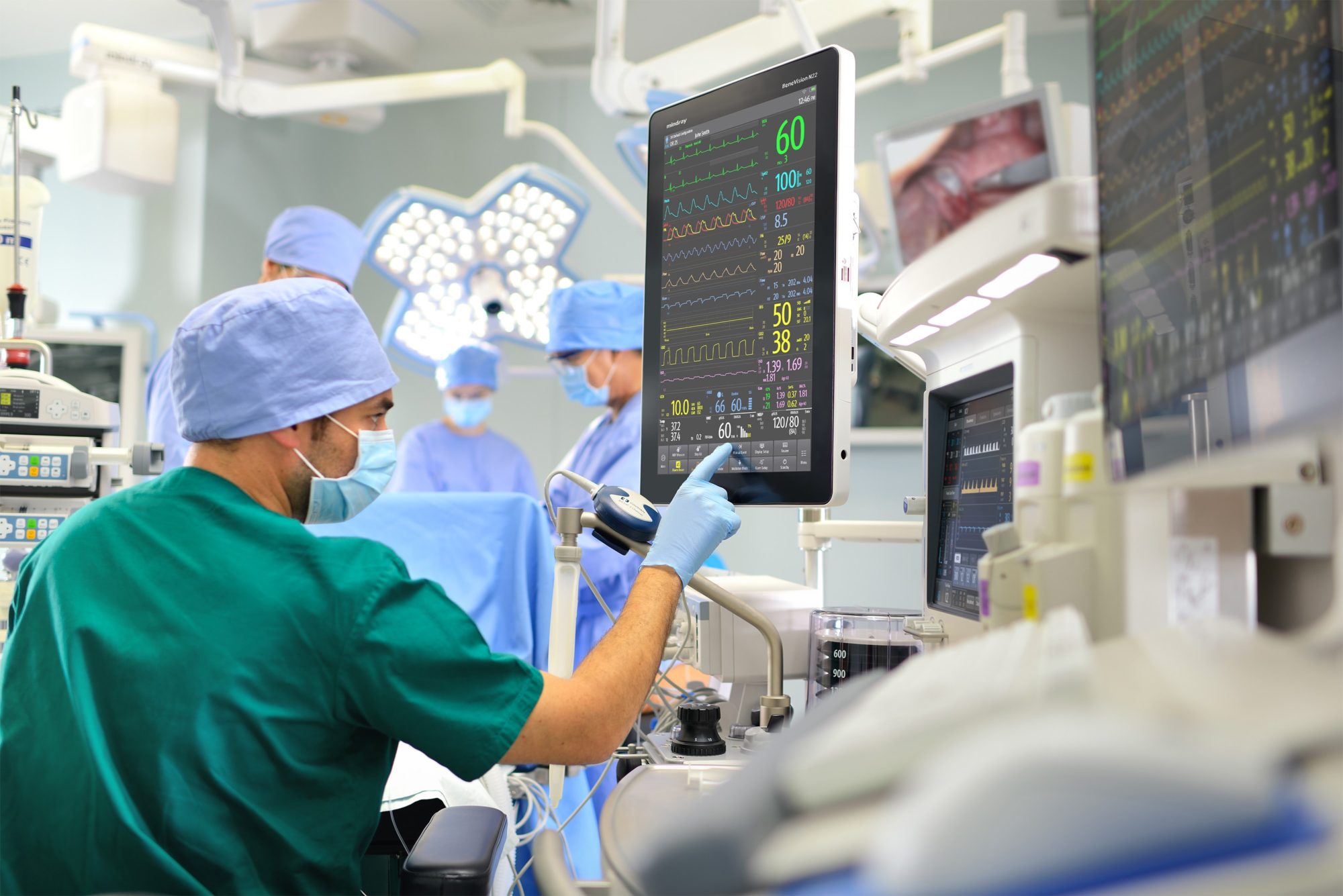 A doctor reviewing information on a computer screen in an operating room