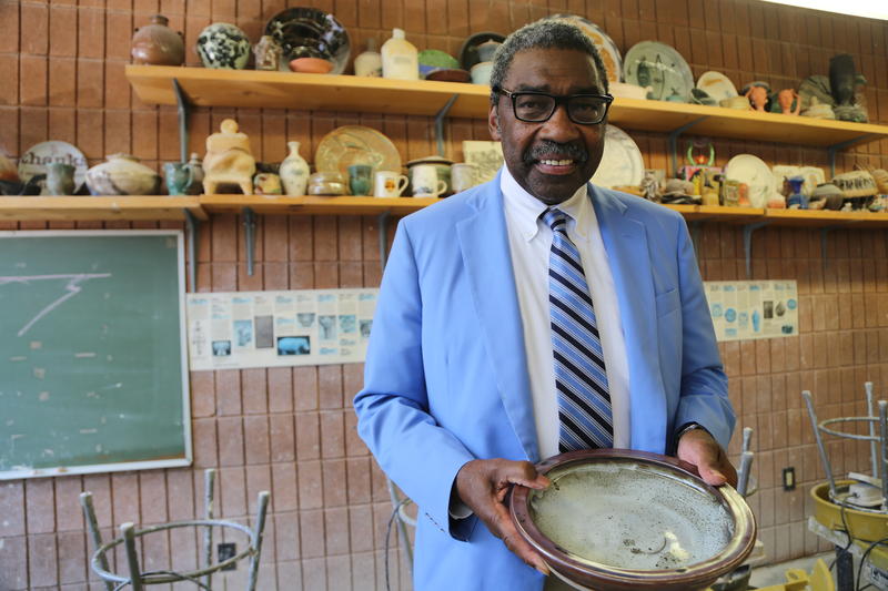 bill strickland, posing with ornate and antique artwork in a pittsburgh cultural center