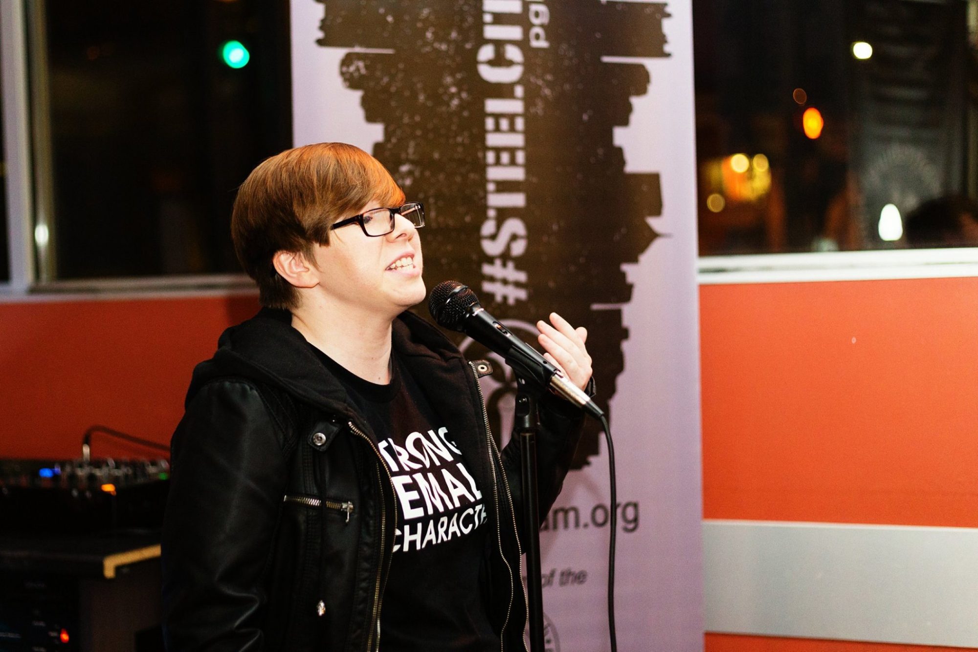 woman speaking at a steel city poetry slam event