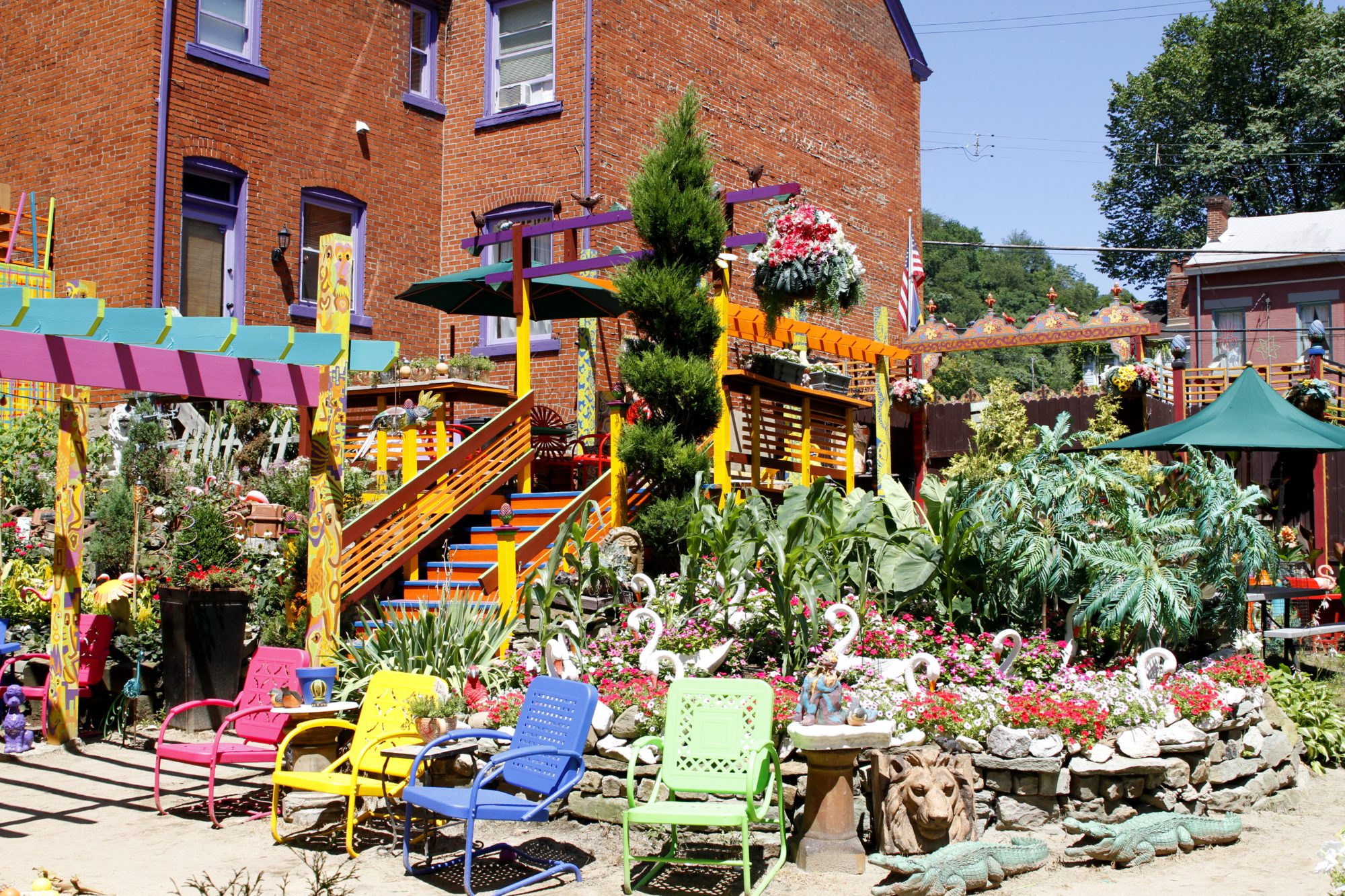colorful chairs surrounded by blooing plants in randyland during the summer