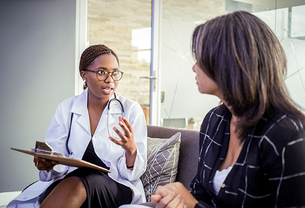 A female doctor talks with a woman