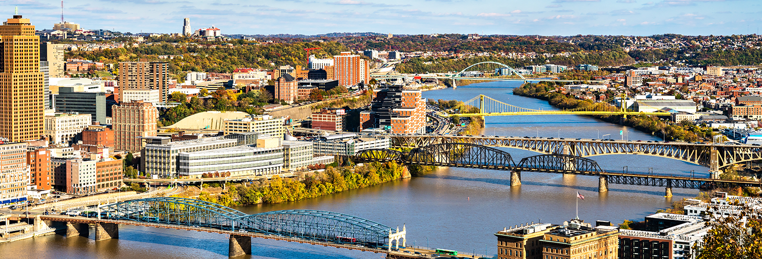 Aerial of five bridges over the Monongahela River connecting downtown Pittsburgh to Station Square and South Side.