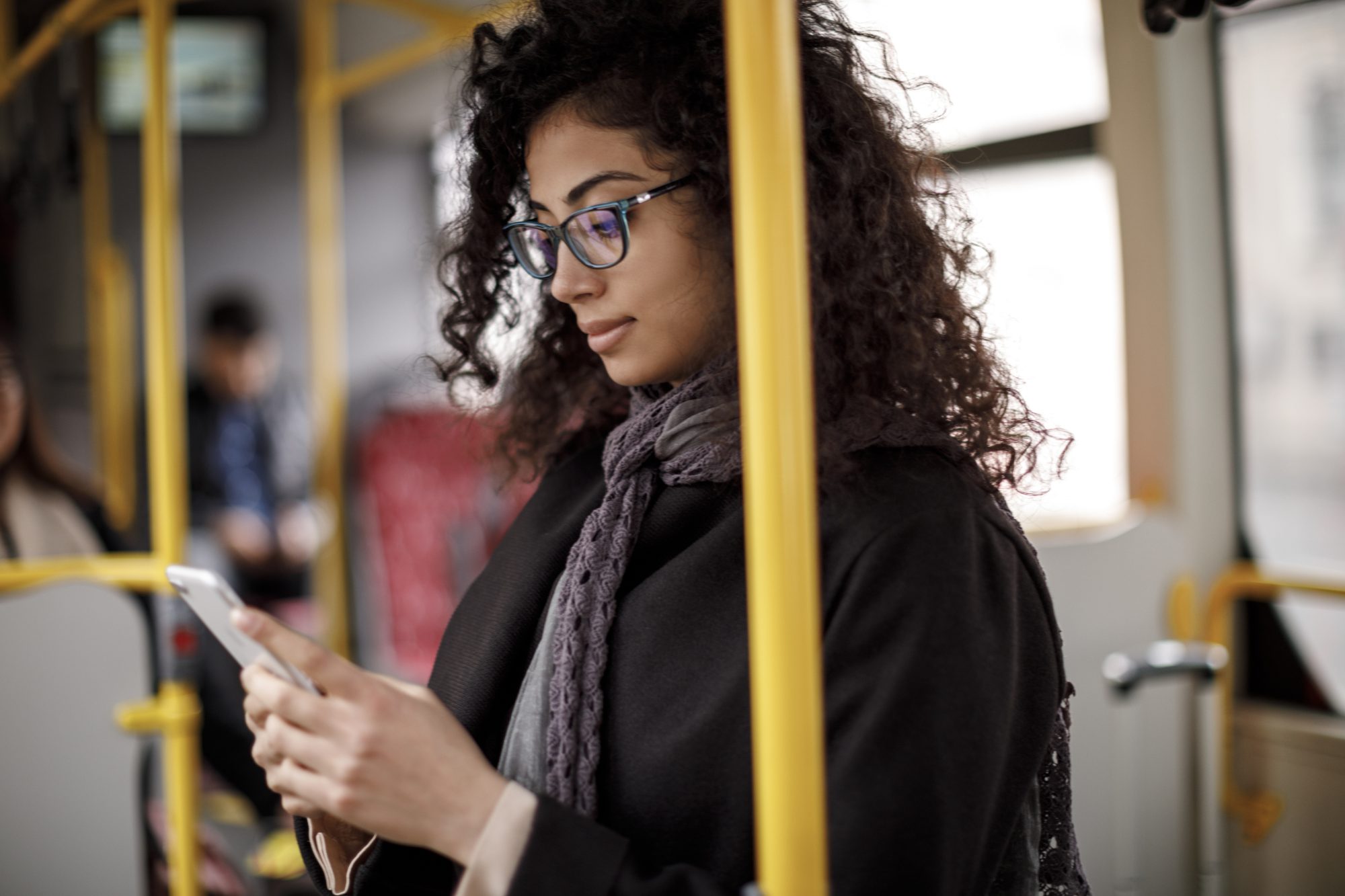 Young woman using a smartphone on a bus 