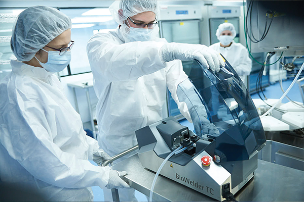 Group of scientists wearing protective gear working in a lab