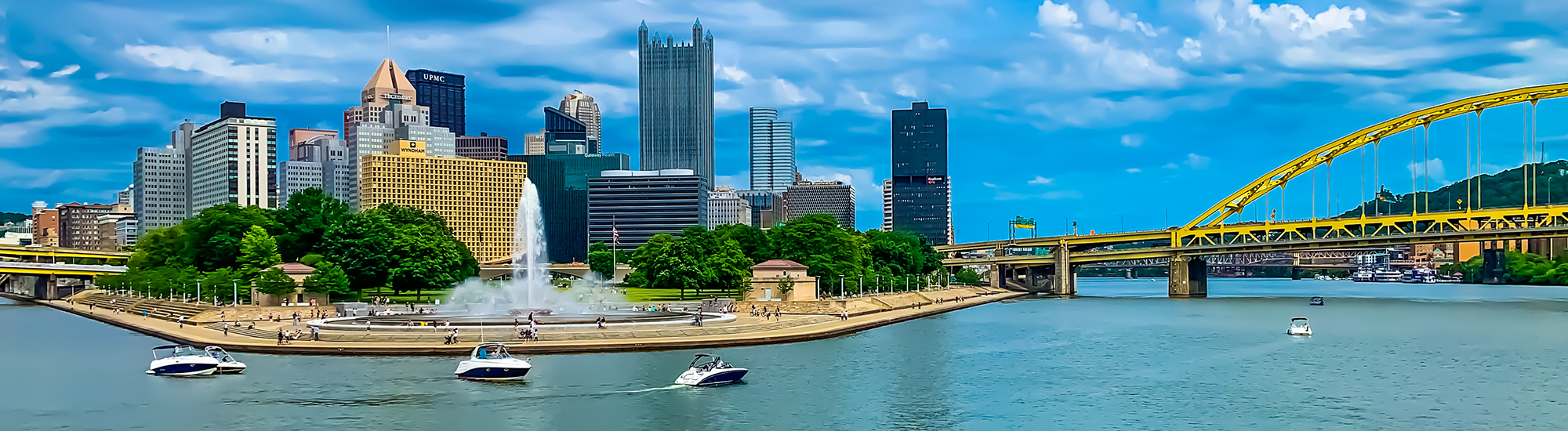 Panoramic view of downtown Pittsburgh with a boats in the foreground.