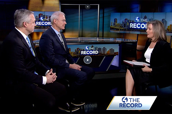 Screenshot of three people sitting for an interview.