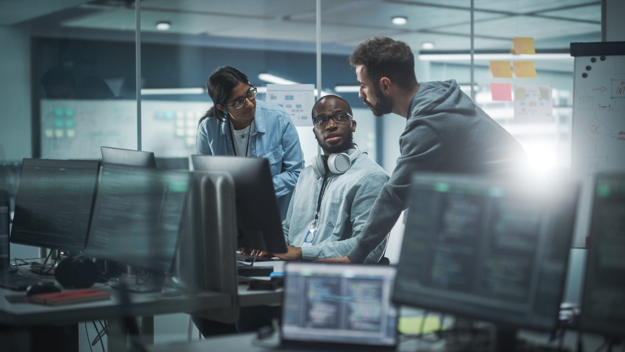 Three technology professionals working together in office on artificial intelligence