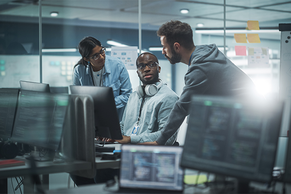 Three technology professionals working together in office on artificial intelligence