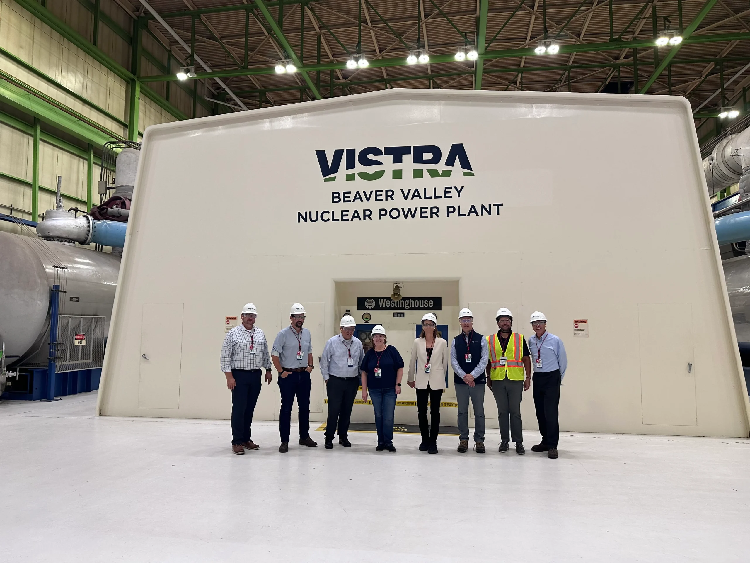 A team standing in front of an energy plant in Beaver County