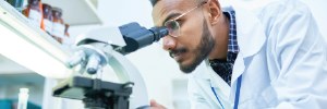 Man looking through microscope